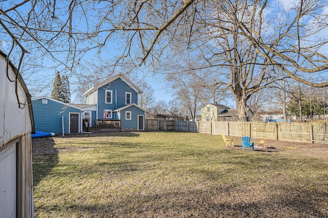 view of yard with an outdoor structure and a fenced backyard