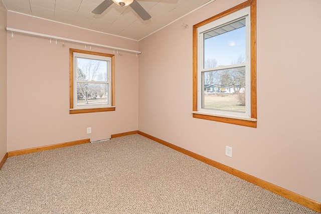 empty room featuring baseboards, carpet, and ceiling fan