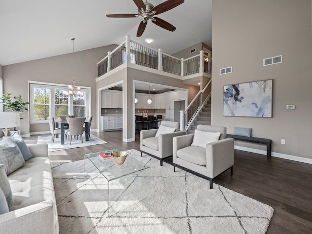 living room with high vaulted ceiling, baseboards, wood finished floors, and visible vents