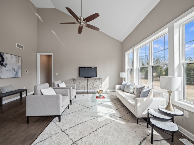 living room with a ceiling fan, wood finished floors, high vaulted ceiling, and a healthy amount of sunlight