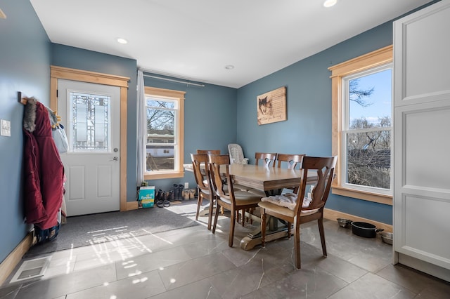 dining space with recessed lighting, a healthy amount of sunlight, visible vents, and baseboards