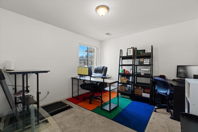 carpeted home office with visible vents and baseboards