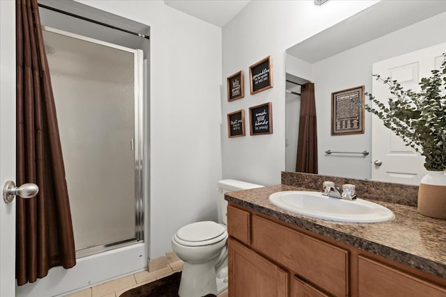 bathroom with tile patterned flooring, toilet, vanity, and a stall shower