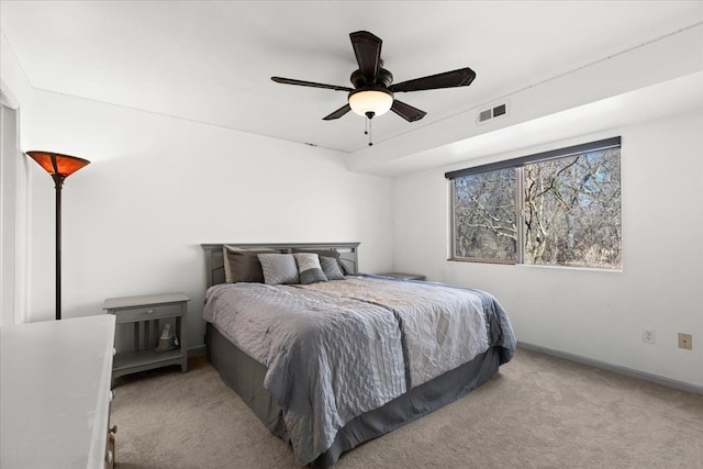 carpeted bedroom featuring visible vents, a ceiling fan, and baseboards