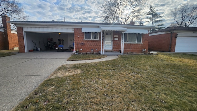 view of front facade featuring brick siding, a front lawn, a chimney, a garage, and driveway