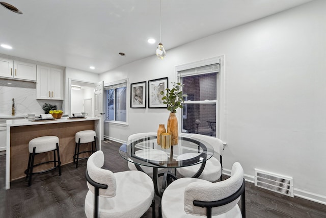 dining area with dark wood-type flooring, recessed lighting, baseboards, and visible vents