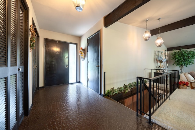 entrance foyer with beamed ceiling and a chandelier