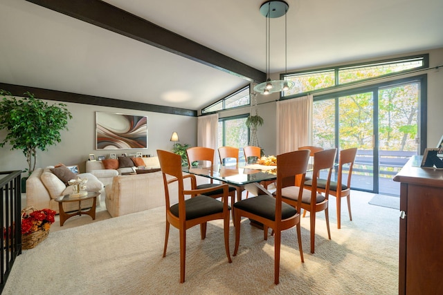 dining room featuring vaulted ceiling with beams and light colored carpet