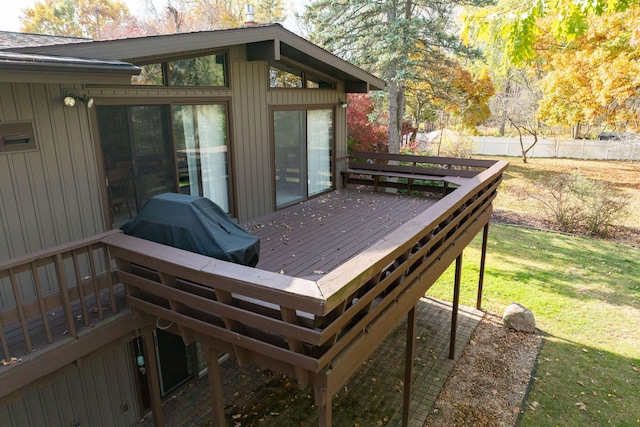 wooden terrace with a yard and fence