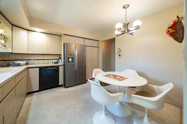 kitchen featuring decorative light fixtures, backsplash, stainless steel fridge, light countertops, and dishwasher