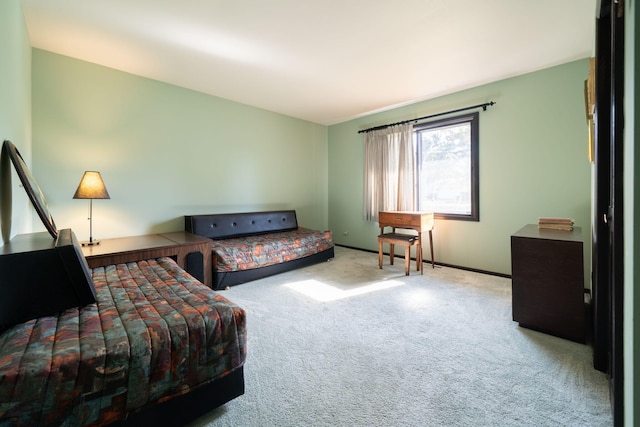 bedroom with baseboards and carpet floors