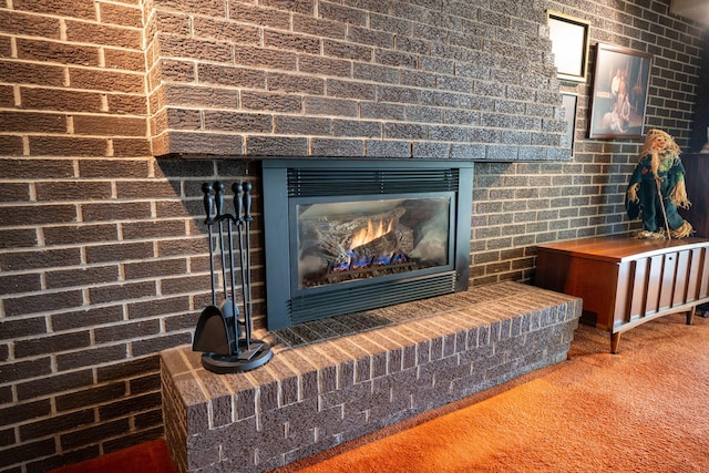 interior details with carpet flooring and a brick fireplace