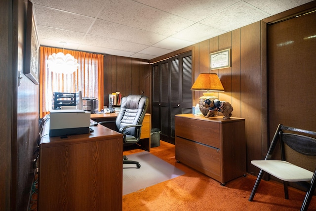 carpeted office space with wooden walls