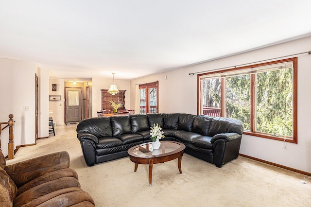 living room featuring light colored carpet and baseboards