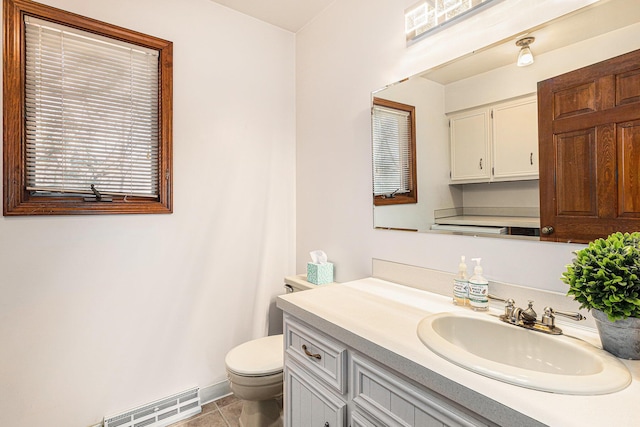 bathroom with tile patterned flooring, visible vents, baseboards, toilet, and vanity