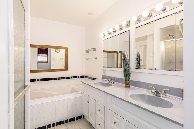 bathroom with a sink, a garden tub, a shower stall, and tile patterned flooring