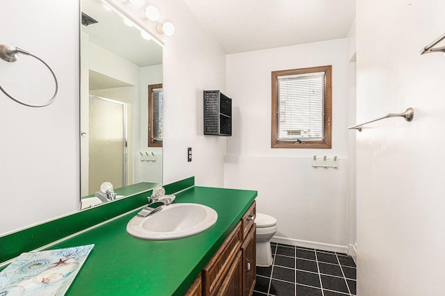 full bathroom featuring baseboards, toilet, a stall shower, tile patterned floors, and vanity