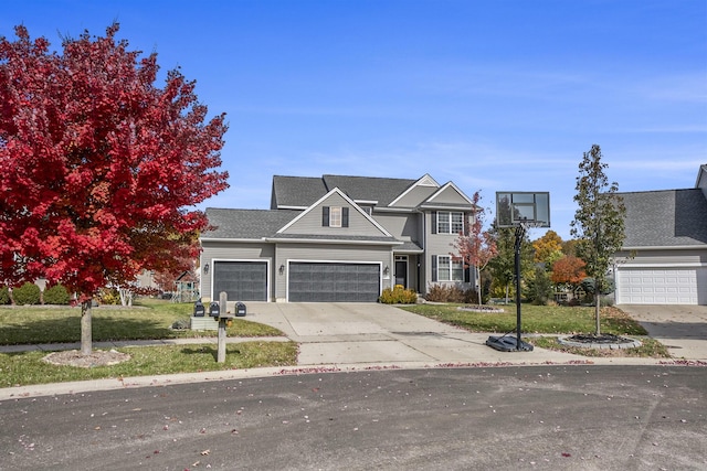 traditional home with a garage, a front lawn, and driveway