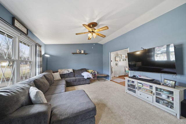 living area with ceiling fan, carpet, and lofted ceiling