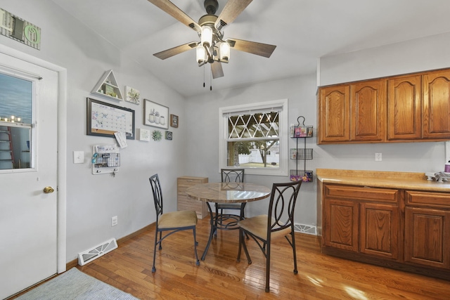 dining area featuring hardwood / wood-style floors, baseboards, visible vents, and a ceiling fan