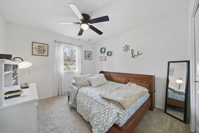 carpeted bedroom with a ceiling fan and baseboards