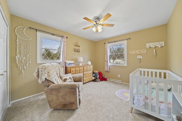 bedroom featuring baseboards, multiple windows, and baseboard heating