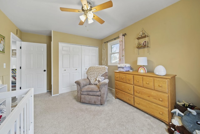 bedroom with light carpet, ceiling fan, and a closet