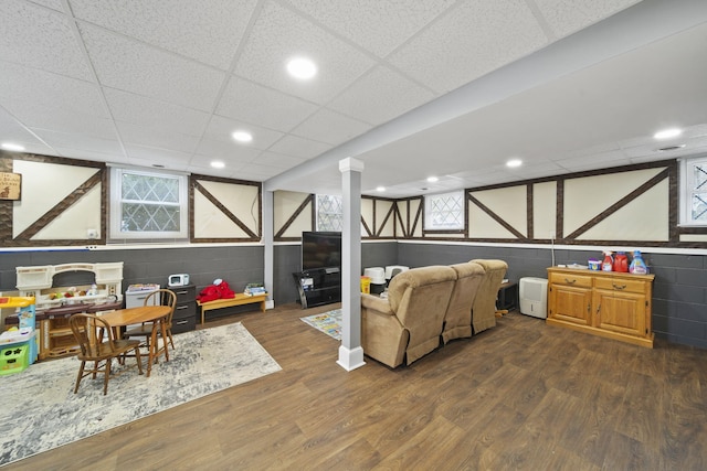 playroom featuring recessed lighting, wood finished floors, and concrete block wall