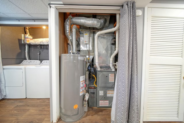 utility room with water heater and washing machine and dryer