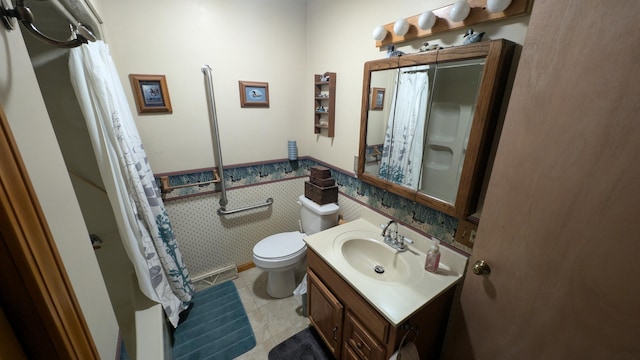 full bath with wallpapered walls, toilet, wainscoting, tile patterned floors, and vanity