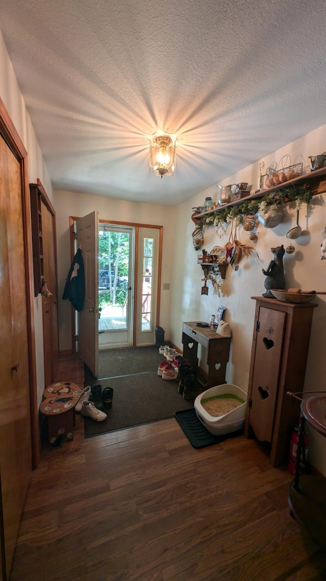 entrance foyer with a textured ceiling and wood finished floors