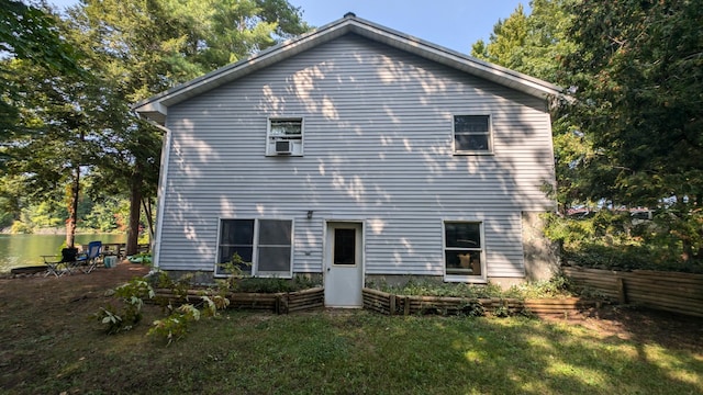 rear view of property with a lawn and fence