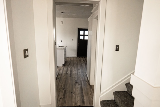 2552 N La Salle Gdns, Detroit, MI 48206 - hallway with dark wood-style flooring, stairway, baseboards, and a sink