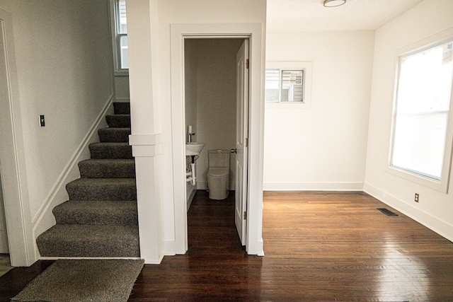 2552 N La Salle Gdns, Detroit, MI 48206 - stairs with visible vents, a healthy amount of sunlight, baseboards, and wood finished floors