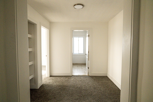 2552 N La Salle Gdns, Detroit, MI 48206 - hall with dark colored carpet and baseboards