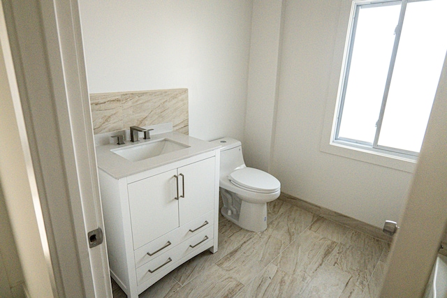 2552 N La Salle Gdns, Detroit, MI 48206 - half bathroom featuring backsplash, toilet, vanity, and baseboards