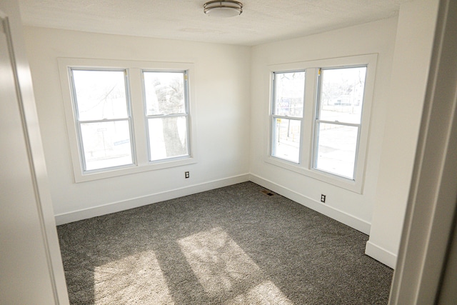 2552 N La Salle Gdns, Detroit, MI 48206 - unfurnished room featuring visible vents, baseboards, and dark colored carpet
