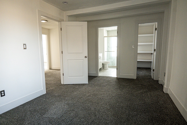 2552 N La Salle Gdns, Detroit, MI 48206 - unfurnished bedroom featuring connected bathroom, baseboards, and dark carpet
