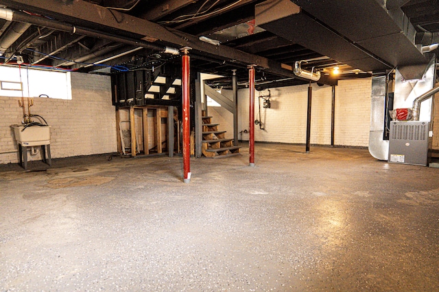 2552 N La Salle Gdns, Detroit, MI 48206 - basement featuring stairway, heating unit, brick wall, and a sink