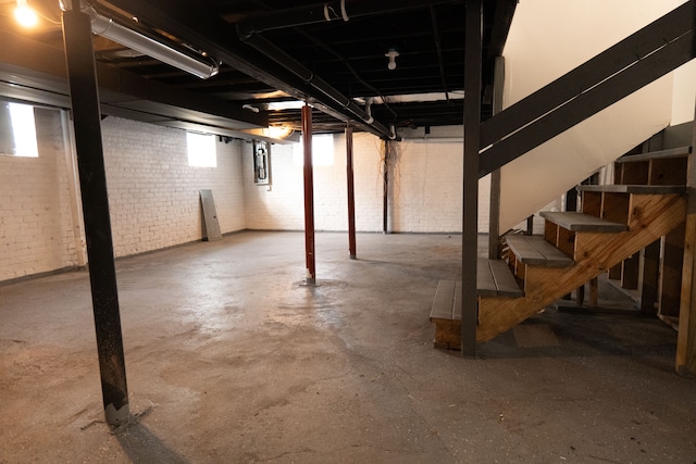 2552 N La Salle Gdns, Detroit, MI 48206 - below grade area featuring a wealth of natural light, stairway, brick wall, and electric panel