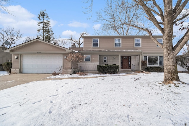 traditional-style house with an attached garage, brick siding, and driveway