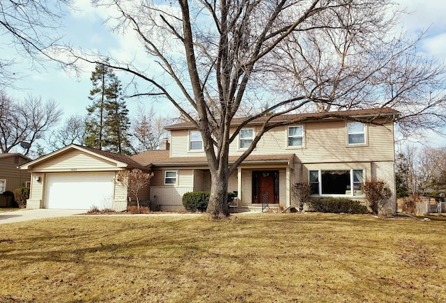 traditional-style house with brick siding, an attached garage, concrete driveway, and a front yard