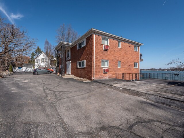 view of side of property with fence and brick siding