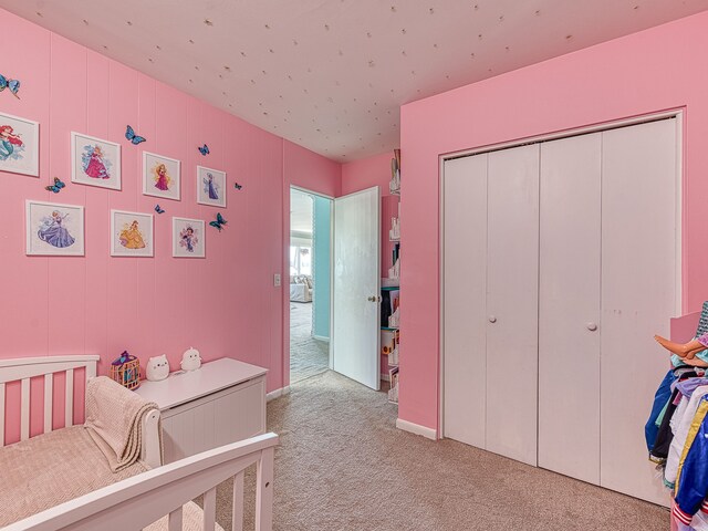 bedroom with a closet and light carpet