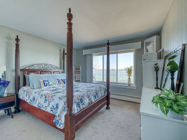 bedroom with light colored carpet and a baseboard radiator