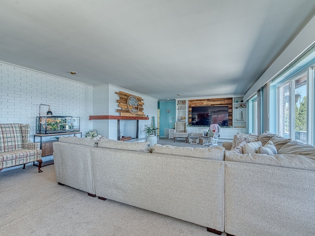 living room featuring carpet flooring, brick wall, a fireplace, and built in features