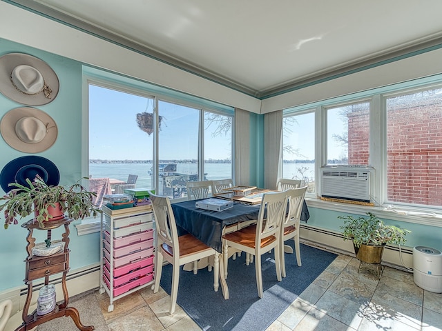 dining area with a baseboard heating unit, a water view, cooling unit, and crown molding