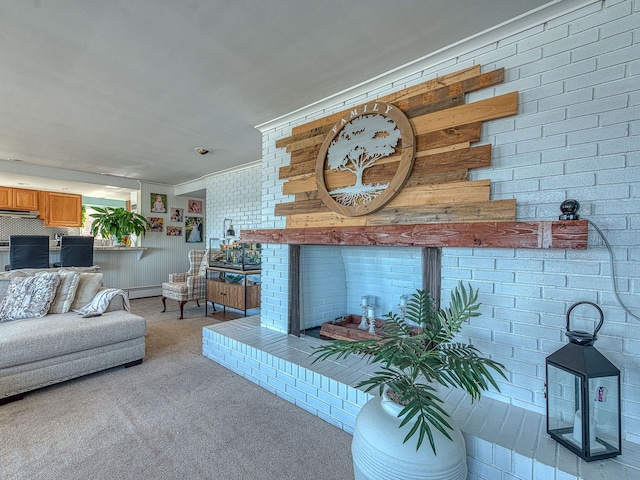 living area with a brick fireplace, brick wall, light colored carpet, and baseboard heating