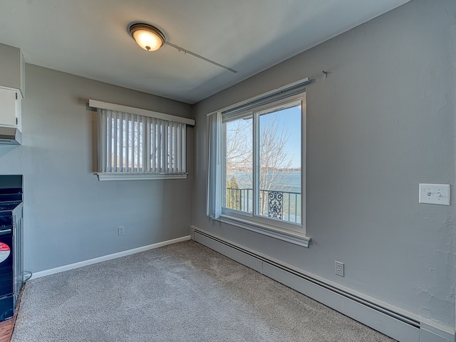 unfurnished room featuring baseboards, carpet, and a baseboard radiator