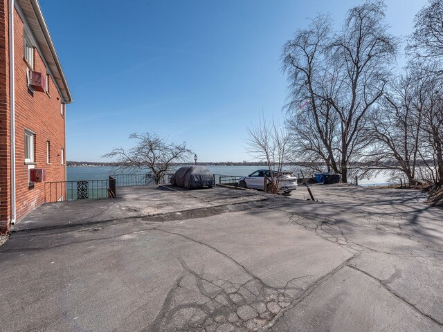 view of parking / parking lot with fence